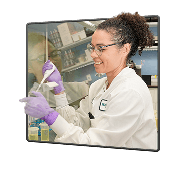 female scientist at Nutramax Laboratories measuring a chemical in a test tube