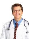 smiling male doctor with stethoscope hanging around his neck